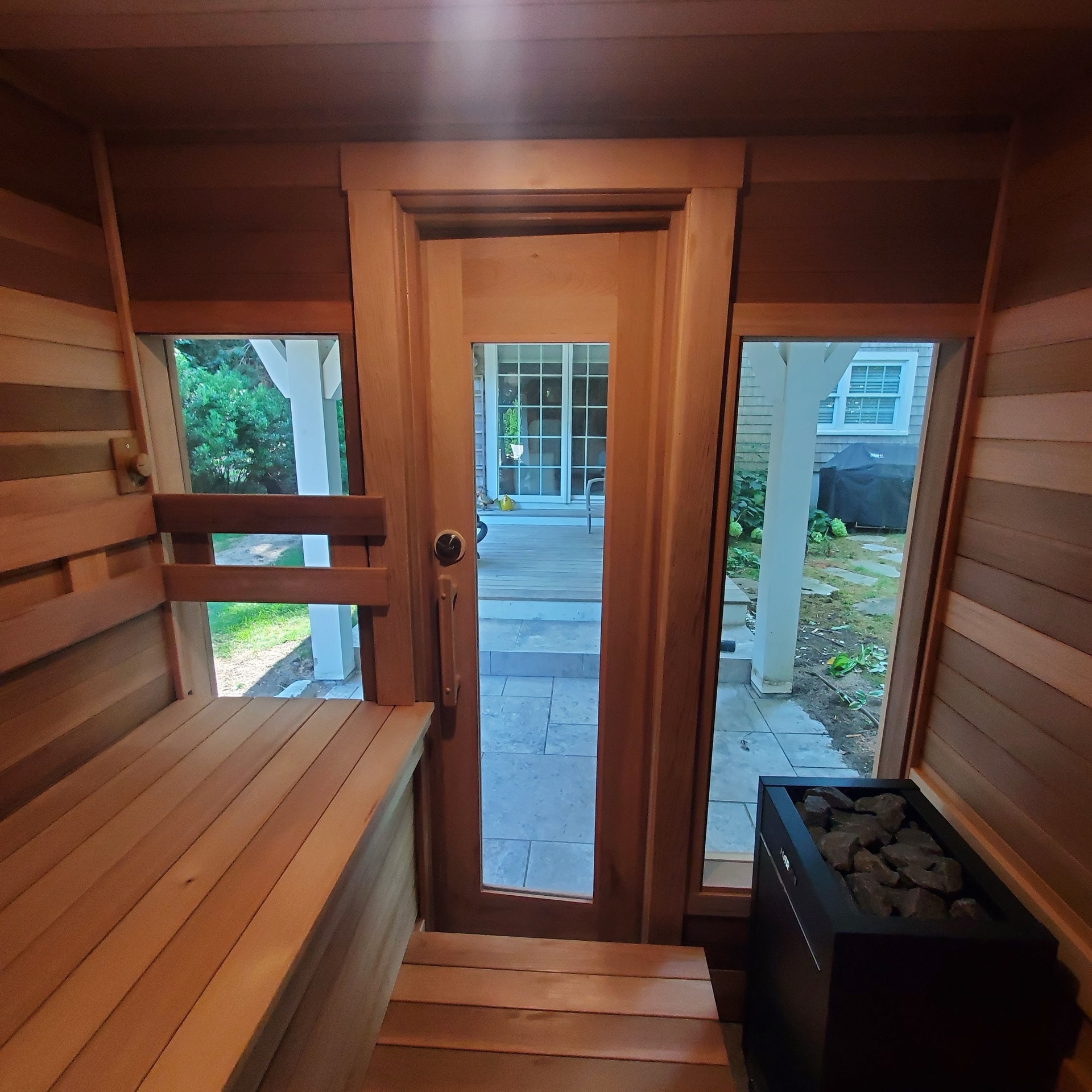 Outdoor sauna interior with garden view